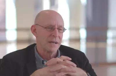 Still of Michael Pollan speaking to the camera in front of a light background