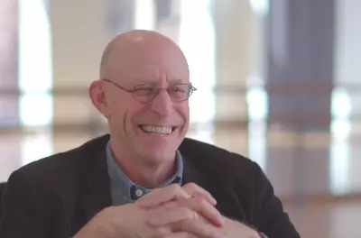 Still of Michael Pollan speaking to the camera in front of a light background