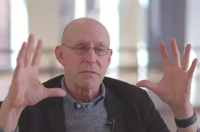 Still of Michael Pollan speaking to the camera in front of a light background