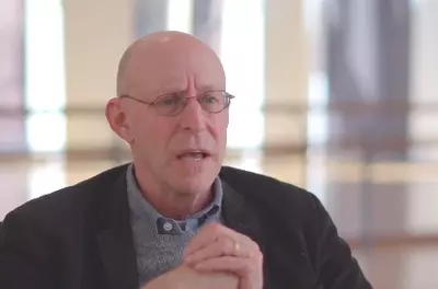 Still of Michael Pollan speaking to the camera in front of a light background