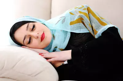 Arabic woman resting on a sofa