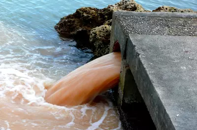 polluted water running from drain pipe