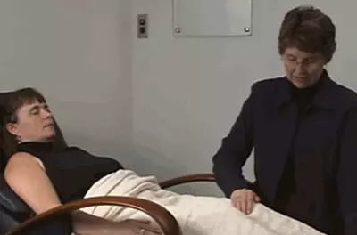 healing touch practitioner touching a client's legs