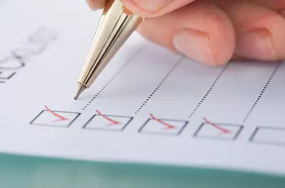 a pencil marking off boxes on a checklist