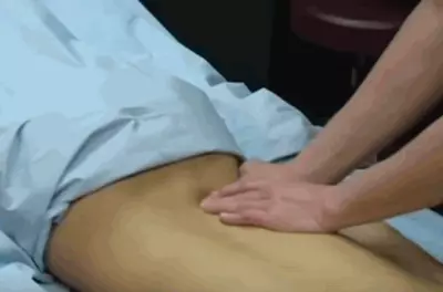 masseuse's hands rubbing a client's bare back