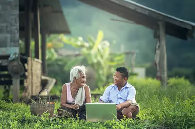 Myanmar kid with grandmother and laptop