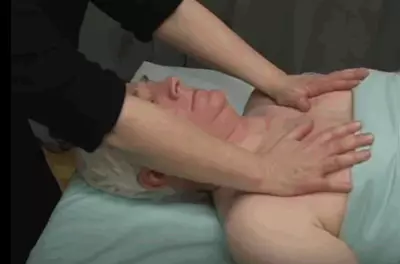 masseuse rubbing a man's chest