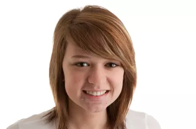 college-age smiling girl against a white background