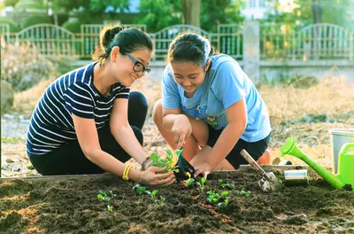 mother and daughter working in garden together