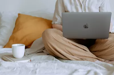 person sitting on couch with laptop