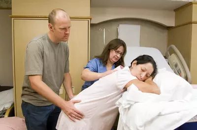 Woman in labor resting standing