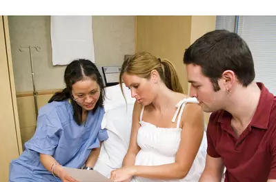 couple reviewing birth plan with nurse