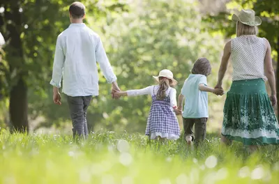 family walking in meadow