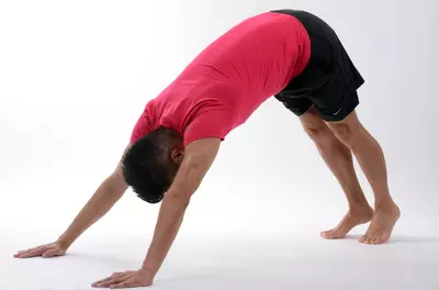 man doing downward dog stretch