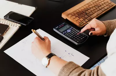 person doing finances on calculator