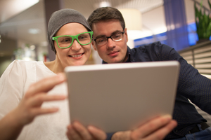 two people looking at an iPad together