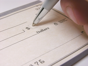 close up of a pen writing on a check