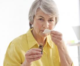 older woman smelling essential oil