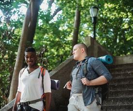 Friends walking on stairs with yoga mats