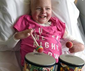 Young girl playing drums