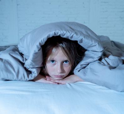 little girl in bed awake