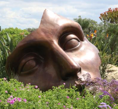 statue of a face in a garden