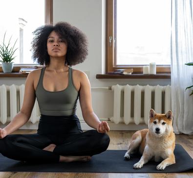 Woman meditating with dog