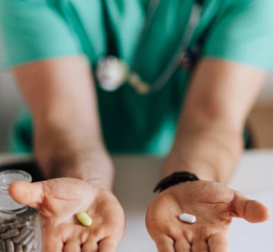 Clinician holding two pills