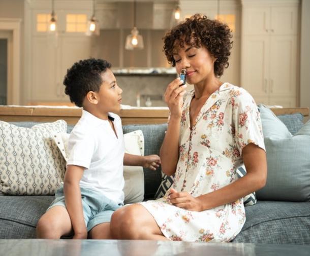 mother and son inhaling essential oils