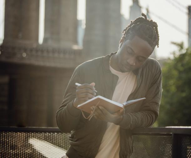 man taking notes on bridge