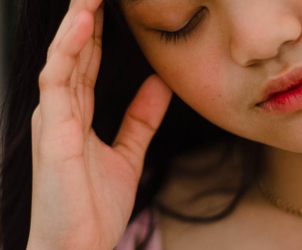 young girl with headache