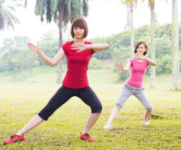 Two women practicing tai chi