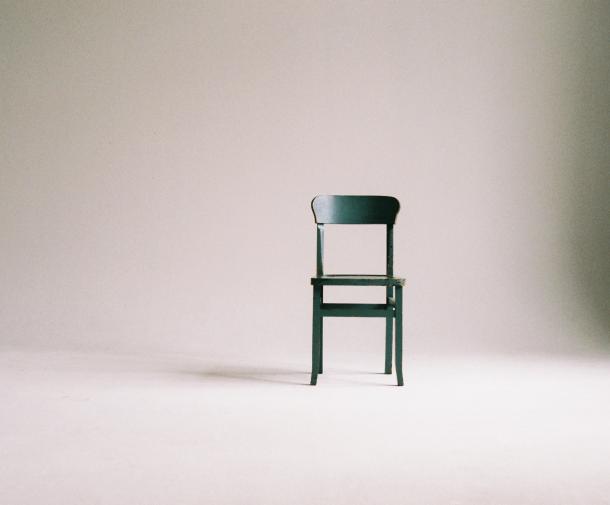 green wooden chair on white surface