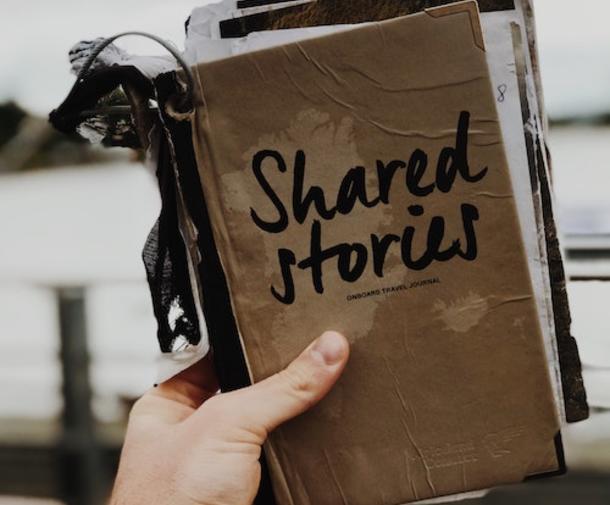 Weathered book that says "shared stories".