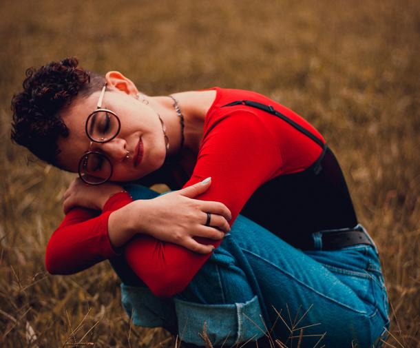 Person in field, looking sad