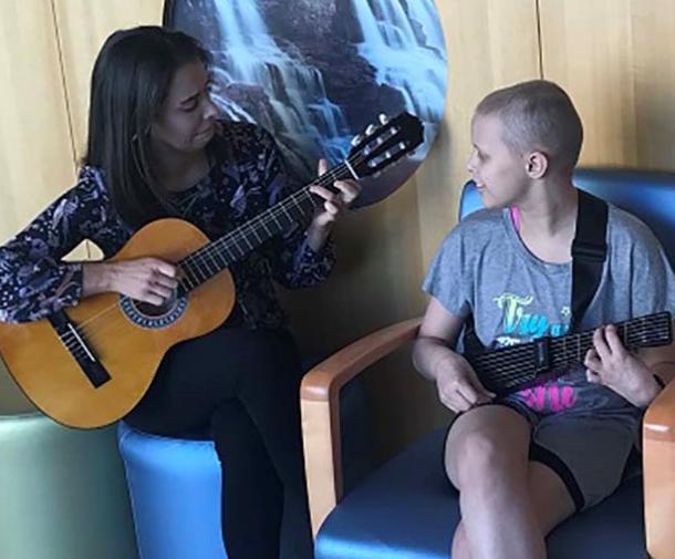 Music therapist and patient playing instruments