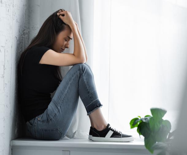 woman looking anxious with hand on head