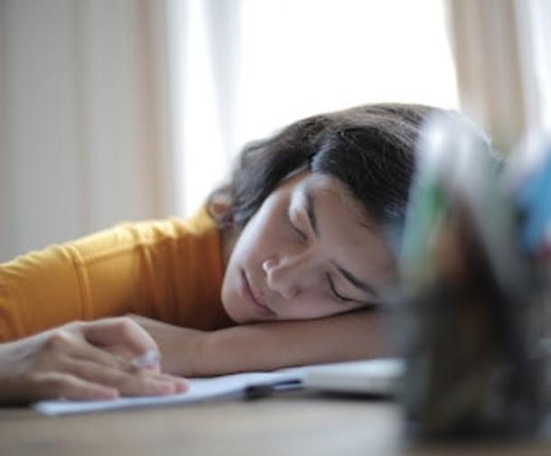 woman sleep on arm while working