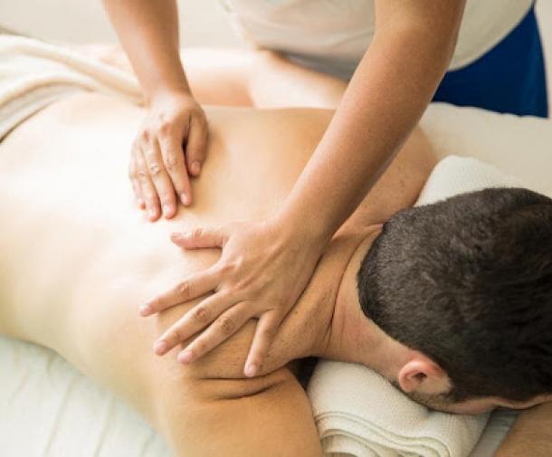 man lying on stomach getting a back massage