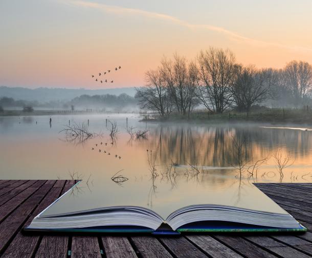 book open on deck with water