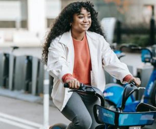 woman smiling and riding bike