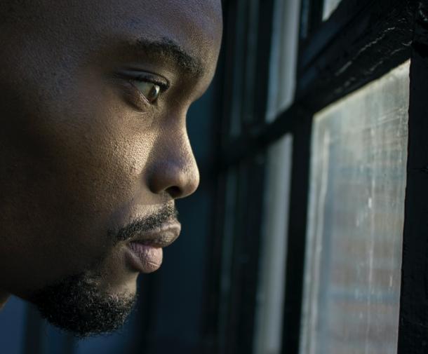 man looking out window