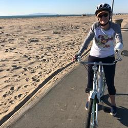 Ruth Bachman biking by beach